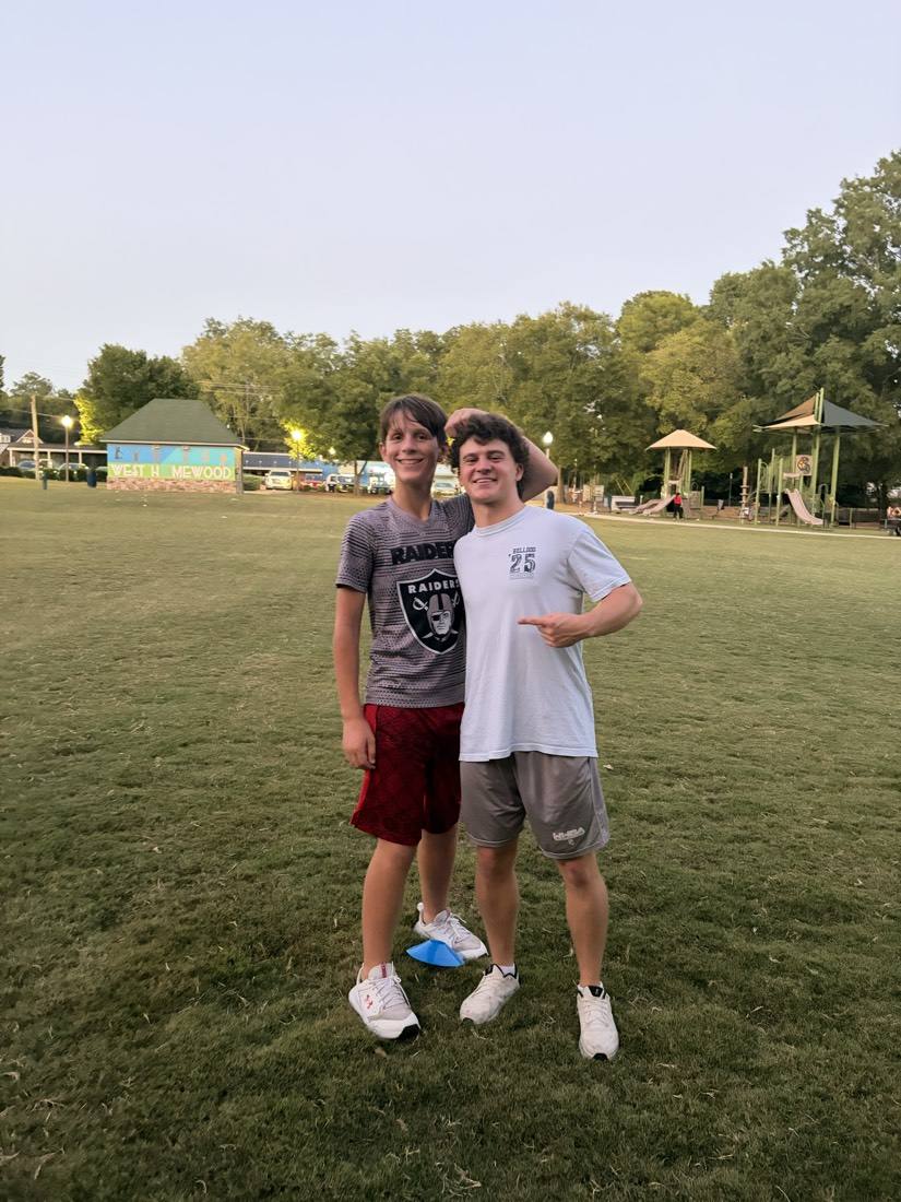 A coach and athlete smiling after a 55 Athletics session