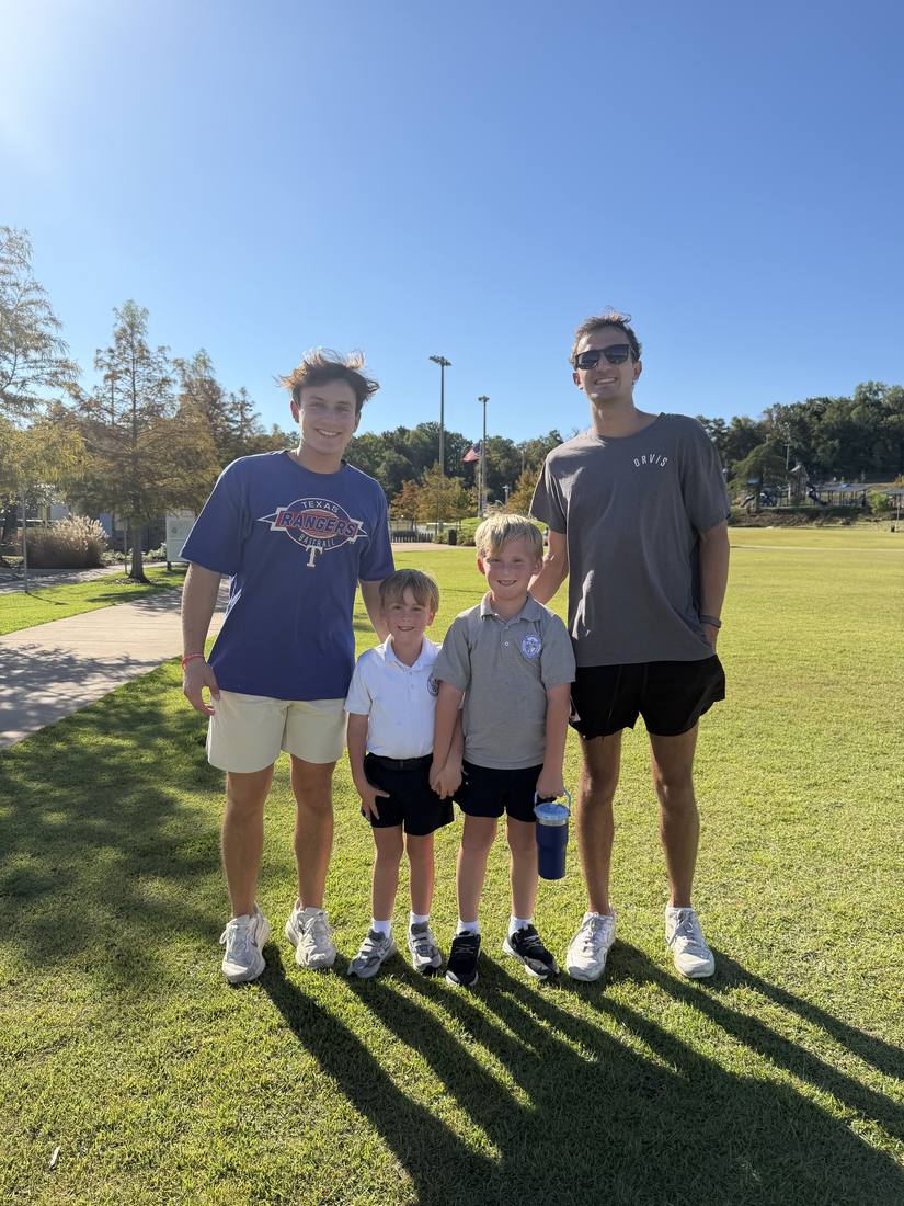 Two 55 Athletics coaches with two young athletes after a session